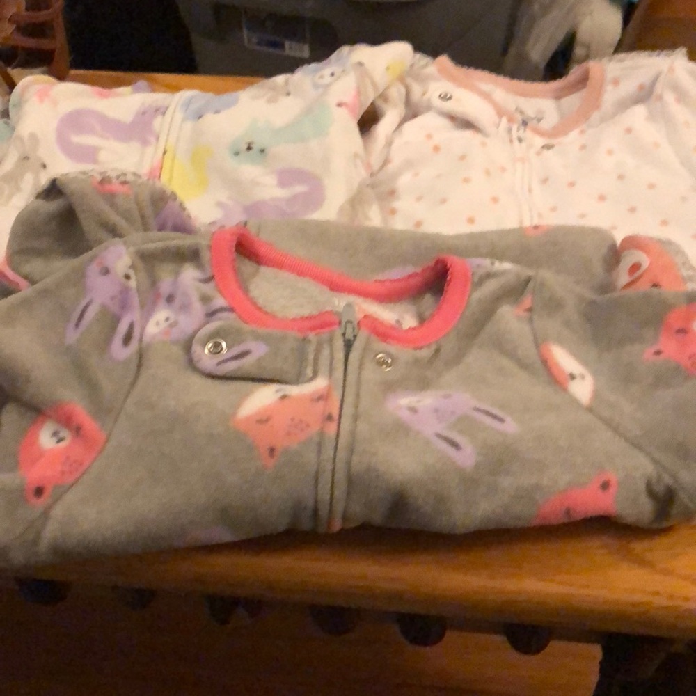 Three pairs of zipped footed pjs